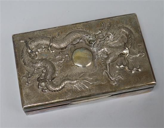 A Hong Kong silver dragon cigarette box and two shoe ashtrays.